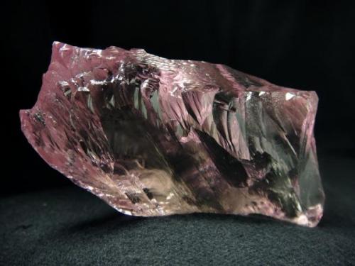 Super gemmy, undamaged, naturally etched  floater crystal of  Kunzite,  from Urucum Mine, Galileia, Minas Gerais, Brazil

Size 70 x 40 x 20 mm (Author: olelukoe)