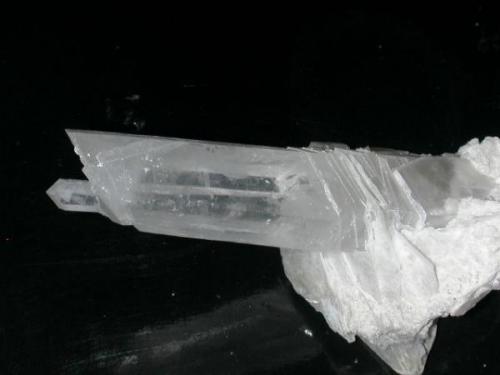 A so-called "sliced quartz" from the Bor mine, Dalnegorsk, Russia, 12 cm long.  The quartz grew among calcite crystals which accounts for the strange "cuts".  Some of the calcite still remains on this piece. (Author: John S. White)