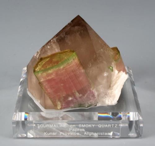 Two pink tourmalines with perfect green terminations on a really nice smokey quartz. This is from Paprok, Afghanistan and is 9 cm tall, and 7 cm in width and length. Weighs 250 grams (Author: VRigatti)