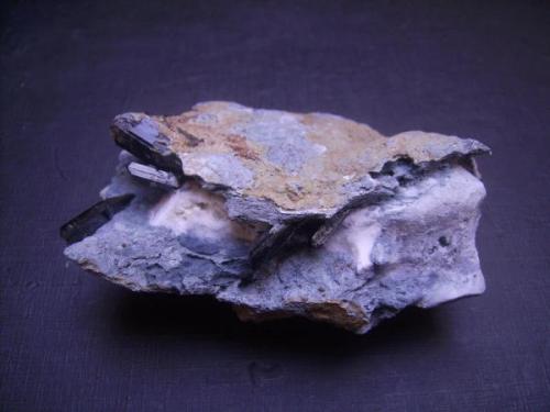 Neptunite on crossite and natrolite matrix with tiny joaquinite crystals. Benitoite Gem Mine, San Benito Co., California. 8,5 x 6 cm. Main crystal measures 2 cm. (Author: Antonio Alcaide)