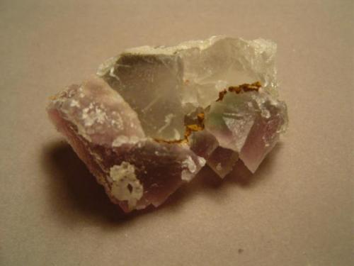 Here the specimen has been rolled forward to expose the obverse (ie, backside) of the specimen.  Note that the darker purple octahedrons have overgrown light blue cubic fluorite, occupying what would be the 111 face for the cubes.  The olde-tyme thinking was that light-colored cubic crystals indicated a lower temperature of formation while the dark octahedral crystals formed at higher temperatures.  So there would have to have been an increase in the temperature of the ore-forming fluid to produce what we have here.  Fluid inclusion study is called for.  But someone else is going to have to provide the rock for study.  Mine stays intact.... (Author: Ed Huskinson)