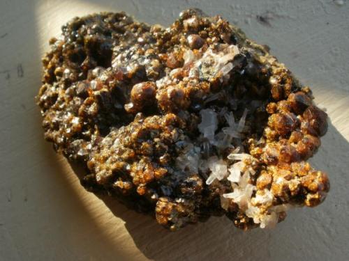 Andradite (heavily etched) and Quartz, Orogrande, Otero County, NM. About 10 cm. (Author: Darren)