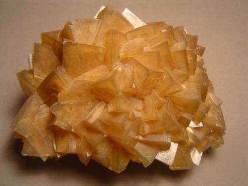 Calcite
Crystal Cavern, Terlingua Mercury District , Brewster Co., Texas, USA
9.5 cm X 10 cm.

Calcite, rhombohedral and zoned, same location. 9.5 cm X 10 cm.  This is an example of the calcite that coats the walls, ceiling, and floor of the Crystal Cavern.  The Terlingua Mercury District is characterized by breccia pipes, collapse breccias that formed just a big jumble of limestone boulders.  Caves are not uncommon in the mines of the district.  Lots of open cavities means good collecting. (Author: Ed Huskinson)