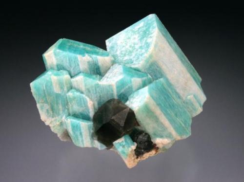 Microcline (Amazonite) with Smoky Quartz, Lake George, Park County, CO. Microcline shows "striped" white overgrowth (likely albite) of selected faces. 4x4x3 cm overall size. (Author: Jesse Fisher)