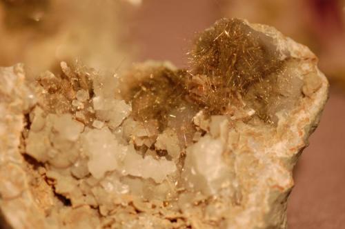Millerite, acicular with calcite crystals in limestone. Ex Dr. Marvin Rausch. (Author: Gail)