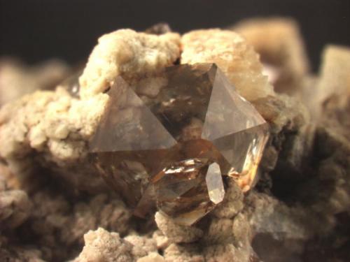 Quartz, transparent and "smoky".
These crystals have very reduced prism faces.
Huron River near Milan, OH
Main crystal is 5.3 mm wide. (Author: Pete Richards)