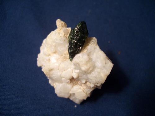 This dark green Diopside is from the Mulvaney Property, Pitcarin, Saint Lawrence County, New York and measures 5/8" x 3/16" (1.59 cm x 0.48 cm) (Author: Jim Prentiss)