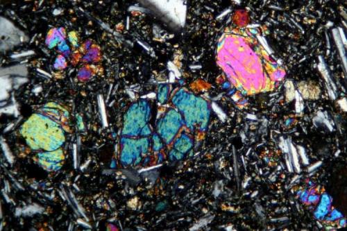 Olivine (forsterite) phenocrysts, with minor pyroxene in a ground mass of plagioclase feldspar. Kilauea volcano, Hawaii. FOV is about 3 mm. (Author: Jesse Fisher)