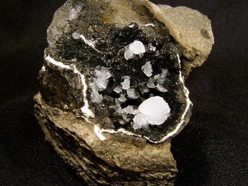 Epistilbite
Sgurr nam Boc, Isle of Skye, Scotland, UK
Largest ’ball’ is 6 mm x 4 mm. Cavity is 3 cm x 2 cm.

Epistilbite in single crystals and aggregates - largest ’ball’ is 6mm x 4mm. Cavity is 3cm x 2cm. Self-collected in 1997 from Sgurr nam Boc. 
{Ref:- Green,D.I. & Wood,M. (1996) Epistilbite from the Isle of Skye, Scotland. Journal of the Russell Society 6(2), p85-87. (Author: Mike Wood)