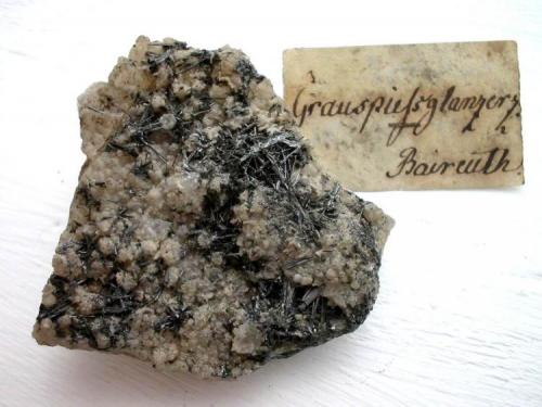 Antimonite crystals up to 1 cm on quartz matrix. Very old sample from Brandholz-Goldkronach (in the old days district of Bayreuth or "Baireuth" as the label tells), Fichtelgebirge, Bavaria. (Author: Andreas Gerstenberg)