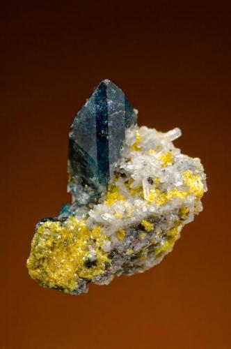 Betpakdalite (canary yellow) with Scorodite and Quartz
Tsumeb, Namibia
Size: Miniature

Specimen: William Pinch Collection
Photo: Jeff Scovil & The RRUFF Project (Author: Pinch Bill)