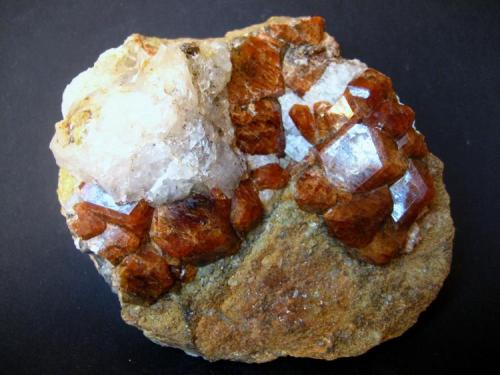 Grossular var. Hessonite.
Žulová, Olomouc Region, Moravia, Czech Republic.
105 x 95 x 50 mm, largest crystal 20 mm. (Author: Tobi)