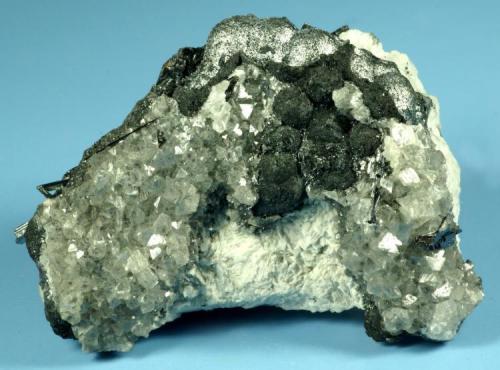 Senarmontite xls on Pääkkönenite balls
Caiwa Mine, Danfeng County, Shaanxi, China
Specimen size: Small cabinet

Specimen: William Pinch Collection
Photo: Jeff Scovil & The RRUFF Project (Author: Pinch Bill)