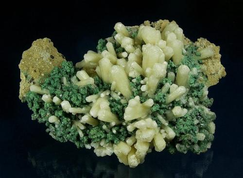 Aragonite ( var. Tarnowitzite ) Malachite
Tsumeb Mine, Tsumeb District, Oshikoto Region, Namibia
113.0 x 85.0 x 54.0 mm
Pale-yellowish prismatic hexagonal crystals of Plumboan Aragonite or "Tarnowitzite", the largest measuring 18 x 8 mm, with good luster.  Sparkly green rosettes of Malachite to 3 mm are nestled amongst the Tarnowitzite. This is a superb Tsumeb specimen from the Earl Calvert collection. (Author: GneissWare)