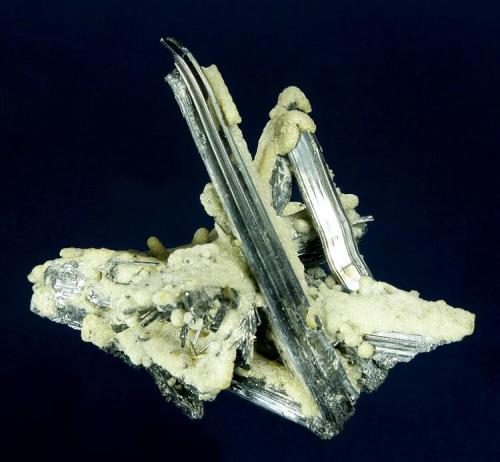 Stibnite with Calcite(?)
Xikuangshan Sb deposit, Lengshuijiang Co., Loudi Prefecture, Hunan Province, China
9.2 x 7.3 x 6.2 cm
Mirror bright Stibnite crystals to 7.5 cm are partly to completely coated with fine crusts of whitish Calcite(?), which nicely accents the Stibnites. This is an attractive three-dimensional specimen. (Author: GneissWare)