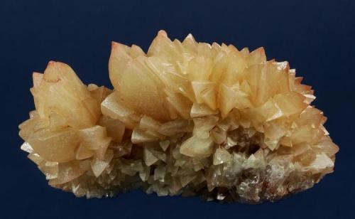 Calcite
Southwest Mine, Warren District, Bisbee, Cochise County, Arizona, USA
83 x 55 x 41 mm

Light orange-brown (hematite-included?), sharp rhombs of Calcite are intergrown and cover this specimen. Some of the crystals have distinct rusty-red tips. This is a classic Calcite from this well-known locality. (Author: GneissWare)