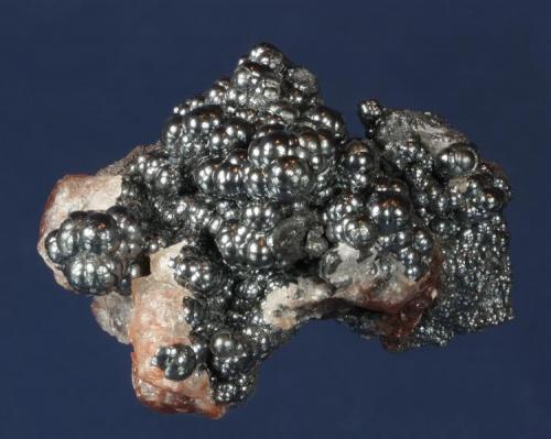 Hematite
Warren District, Bisbee, Cochise County, Arizona, USA
49 x 36 x 33 mm

Lustrous, battleship grey Hematite in aggregates of spheroids to 4 mm almost completely cover this specimen. It is nicely accented with pinkish Calcite. (Author: GneissWare)
