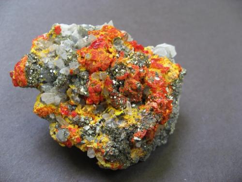 Pyrite, realgar, pararealgar, orpiment, quartz
Palomo Mine, Castrovirreyna, Huancavelica, Peru
6.4 x 5 x 3.2 cm (Author: B&A)