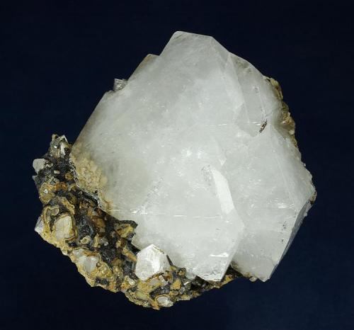 Quartz
Second Sovietskiy Mine, Dal’negorsk, Primorskiy Kray, Russia
71.0 x 68.0 x 46.0 mm

A complex, highly lustrous, opaque crystal of bright white Quartz measuring 68 x 59 x 36 mm is nicely perched on a perfectly trimmed, iron-stained matrix. No damage. (Author: GneissWare)