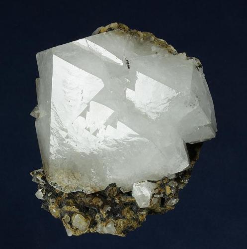 Quartz
Second Sovietskiy Mine, Dal’negorsk, Primorskiy Kray, Russia
71.0 x 68.0 x 46.0 mm

A complex, highly lustrous, opaque crystal of bright white Quartz measuring 68 x 59 x 36 mm is nicely perched on a perfectly trimmed, iron-stained matrix. No damage. (Author: GneissWare)