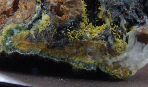 Plumbogummite, Mimetite, Quartz, Limonite and  Manganese Oxides
Dry Ghyll, Caldbeck Fells, Cumbria.
Here we see what appears to be a layer of Mimetite with a layer of Plumbogummite on top of it with a layer of Manganese Oxide on top of that, neat eh? FOV 20 mm across approx (Author: nurbo)