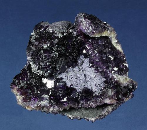 Fluorite
Huanggangliang Iron Mine, Kèshíkèténg Qí, Chifeng, Inner Mongolia A.R., China
85.0 x 67.0 x 42.0 mm
Semi-lustrous, deep-purple Flourite completely covers all sides of this specimen, which consists of parallel and intergrown plates of Fluorite matrix. The Fluorite habits range from sharp, individual cubes to 5 mm, and complex clusters of crystals to 20 mm comprised of many, slightly rounded cubes. A patch of earthy, pale-purple botryoidal material provides an accent. No damage. (Author: GneissWare)