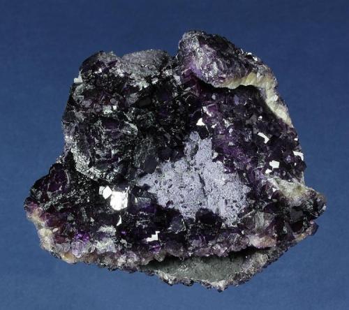 Fluorite
Huanggangliang Iron Mine, Kèshíkèténg Qí, Chifeng, Inner Mongolia A.R., China
85.0 x 67.0 x 42.0 mm
Semi-lustrous, deep-purple Flourite completely covers all sides of this specimen, which consists of parallel and intergrown plates of Fluorite matrix. The Fluorite habits range from sharp, individual cubes to 5 mm, and complex clusters of crystals to 20 mm comprised of many, slightly rounded cubes. A patch of earthy, pale-purple botryoidal material provides an accent. No damage. (Author: GneissWare)
