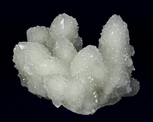 Quartz
Huanggangliang Iron Mine, Kèshíkèténg Qí, Chifeng, Inner Mongolia A.R., China
92.0 x 69.0 x 60.0 mm
Highly lustrous, clear glassy Quartz crystals to 65 x 26 mm, some doubly terminated, are nearly completely covered with a second generation of 1 to 2 mm lustrous, glassy Quartz creating a very sparkly display. No damage. (Author: GneissWare)