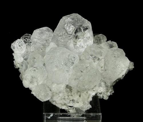 Fluorite
Huanggangliang Iron Mine, Kèshíkèténg Qí, Chifeng, Inner Mongolia A.R., China

85 x 68 x 30 mm

Numerous, water-clear crystals of Fluorite to 26 mm are perched on a matrix of lustrous, white Dolomite crystals.  The Fluorites generally have complexly crystallized faces, although some faces are clear windowpanes.  I can find no point of attachment, and the reverse consists of crystals of Dolomite and Fluorite.  No damage. (Author: GneissWare)