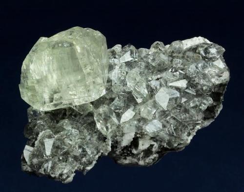 Calcite

Meikle Mine (1450 Level), Bootstrap District, Elko County, Nevada, USA

54 x 39 x 26 mm

Pale yellowish twinned crystal of Calcite to 23 mm rests on a plate covered with water-clear, modified scalenohedrons of Calcite. The large Calcite has promnent twin lines. It was collected by Casey Jones in August 1998. No damage. (Author: GneissWare)