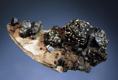 Sphalerite
Grace Walker Mine, Picher Field, Ottawa Co., Oklahoma
7.1 x 11.9 cm
Resinous brownish-black sphalerite crystals to 2.5 cm with epitactic chalcopyrite and small "ruby jack" sphalerite on chert. (Author: crosstimber)