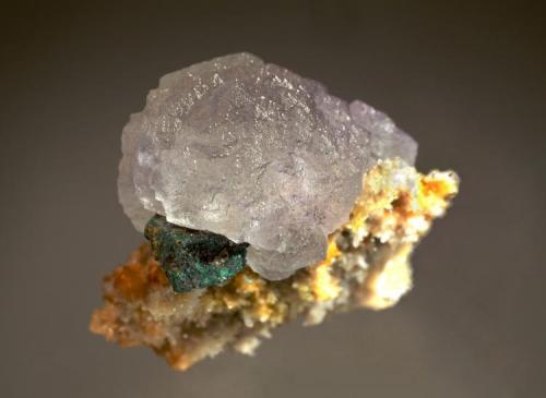 Fluorite
Mex Tex Mine, Ora Tunnel, Bingham, Socorro Co., New Mexico
5.6 x 5.8 cm.
The pale lavender fluorite crystal is composed of hundreds of tiny stacked octahedrons. A small cubic galena crystal partially altered to anglesite provides a nice accent. (Author: crosstimber)