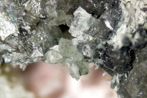 Nepheline
Poudrette quarry (Demix quarry; Uni-Mix quarry; Desourdy quarry; Carrière Mont Saint-Hilaire), Mont Saint-Hilaire, Rouville RCM, Montérégie, Québec, Canada
FOV=4mm
Crude crystals on massive nepheline (Author: Doug)
