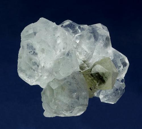 Quartz with Fluorite
Huanggangliang Iron Mine, Kèshíkèténg Qí, Chifeng, Inner Mongolia A.R., China

58 x 50 x 46 mm

A slightly milky, palest green sceptered Quartz measuring 46 x 16 mm is surrounded by a halo of water-clear Fluorites to 25 mm. These Fluorites are of cuboctahedral habit with dodectahedral modifications, and is commonly seen from this Chinese locality, some faces are preferentially etched slightly. Only a very minor chip visible with a 10X loupe is present on the very tip of the Quartz, otherwise no damage. This is a nice association, very aesthetically presented. (Author: GneissWare)