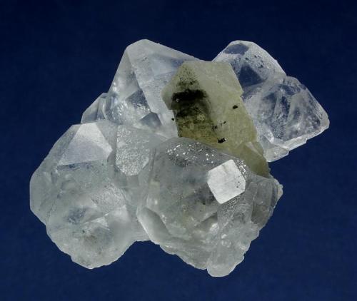 Quartz with Fluorite
Huanggangliang Iron Mine, Kèshíkèténg Qí, Chifeng, Inner Mongolia A.R., China

58 x 50 x 46 mm

A slightly milky, palest green sceptered Quartz measuring 46 x 16 mm is surrounded by a halo of water-clear Fluorites to 25 mm. These Fluorites are of cuboctahedral habit with dodectahedral modifications, and is commonly seen from this Chinese locality, some faces are preferentially etched slightly. Only a very minor chip visible with a 10X loupe is present on the very tip of the Quartz, otherwise no damage. This is a nice association, very aesthetically presented. (Author: GneissWare)