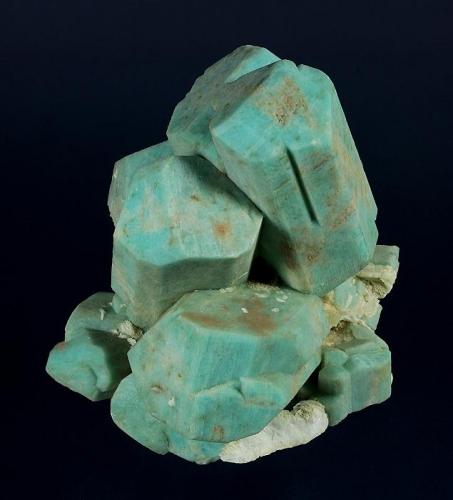 Microcline (v. Amazonite) -- cleaned
Lake George area, Park County, Colorado, USA

130 x 124 x 104 mm

Classic, old-time Colorado Amazonite with sharp, light greenish-blue, blocky crystals of Microcline, on a matrix of white Albite (v. Cleavlandite). The Amazonites are well formed and fully terminated, several of which are well-developed twins. One crystal has a "slot" where it once enclosed a blade of what was likely Cleavlandite. This is an old AE Foote specimen, and was later sold by Filer’s (Redlands, CA) and the Bradleys (Los Angeles). Formerly in the Don Boydston and Joel D. Cohen collections. It is complete on all sides, unrepaired and has no damage. (Author: GneissWare)