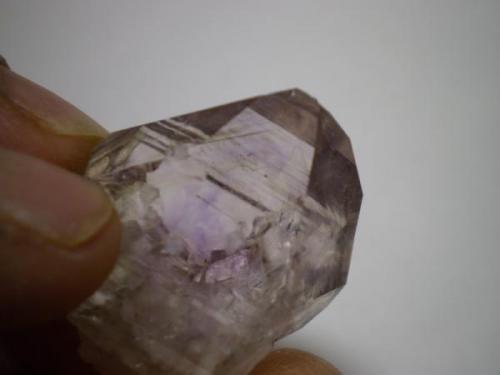 This is the same crystal as the pic above.  You can see the smokey phantom and the purple "
flame" in this pic.  The small mini crystal that is inside this crystal is hard to see due to light refraction but it’s toward the bottom right. (Author: Jason)