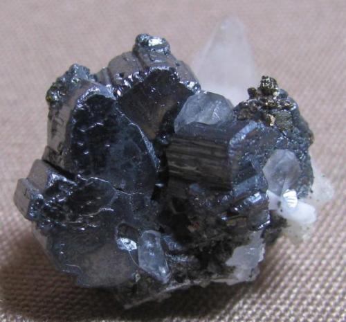 Bournonite, Naica with calcite and fluorite.  These also grow on fluorite.  2 cm. (Author: Peter Megaw)