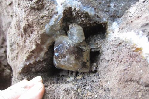 6 cm. or larger, smoky crystal, still in the wall, growing from the roof. (Author: vic rzonca)