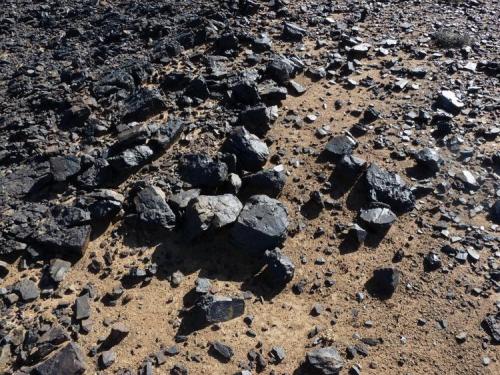 Black, iron bearing rocks are in abundance; some with a jet black colour. (Author: Pierre Joubert)