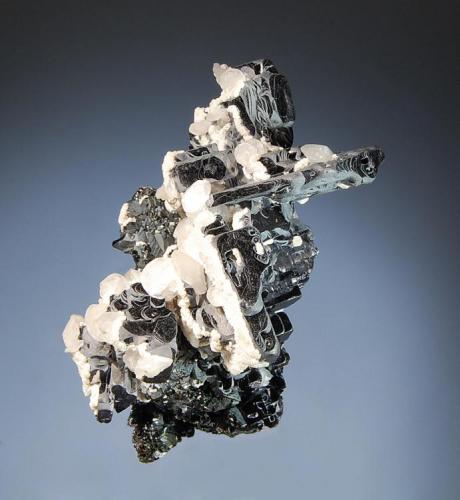 Galena
Kruchev dol Mine, Madan District, Smolyan Oblast, Bulgaria
4.1 x 6.0 cm.
Unusual flattened cubic galena crystals with mosaic-textured dissolution features and 2 generations of calcite. Mined in 2003. (Author: crosstimber)