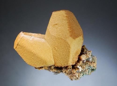 Siderite ps. after calcite
Broken Hill Mine, Aggenys, N. Cape Prov., South Africa
7.1 x 8.2 cm.
Two hollow, brown molds after barrel-shaped calcite crystals with blunt trigonal terminations. (Author: crosstimber)