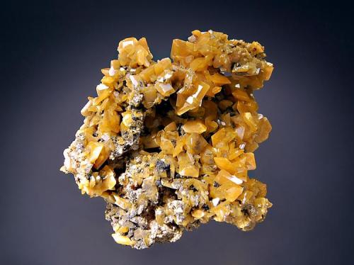 Wulfenite
Zelidja Mine, Touissit, Oujda-Angad Prov., Morocco
6.3 x 6.9 cm.
Tabular yellow wulfenite crystals to 1.0 cm on edge. (Author: crosstimber)