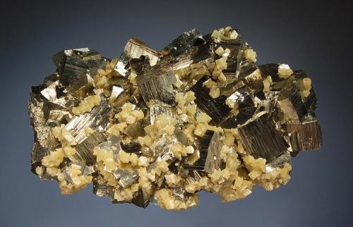 Pyrite
Gheturi Mine, Turt, Satu Mare, Romania
5.1 x 8.0 cm.
In 2001 a series of small pockets was encountered, and they produced a few nice calcites and these cubic pyrites with siderite. (Author: crosstimber)