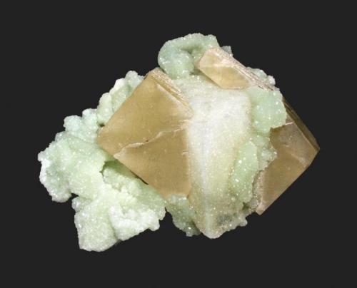 Prehnite and calcite
Weldon Quarry, Watchung, Somerset County, New Jersey
8.2 x 6.5 cm
A prehnite coated calcite rhombohedron with prehnite after glauberite epimorphs, sandwiched by a 6 cm second generation calcite crystal (Author: Frank Imbriacco)