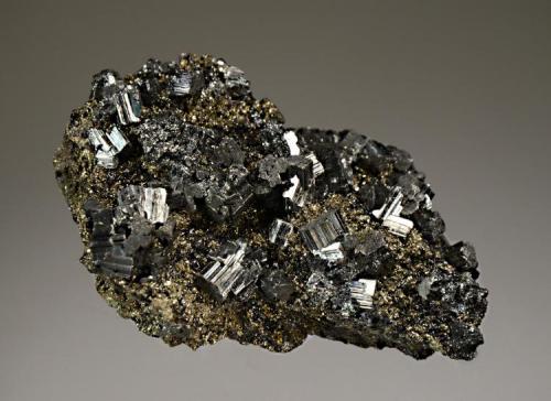 Bournonite
No. 6 Mine, Baia Sprie, Maramures, Romania
4.6 x 7.5 cm.
Steel-gray, striated, bournonite crystals to 0.8 cm scattered over a pyrite matrix. Mined in 2001. (Author: crosstimber)