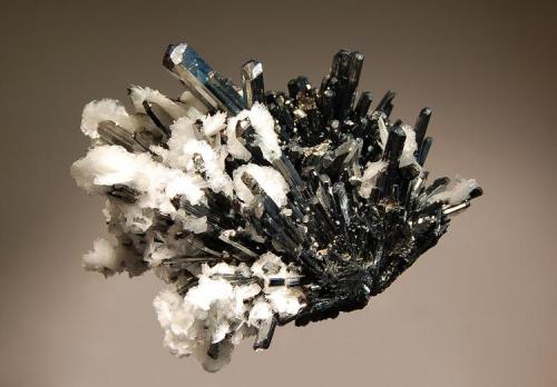 Stibnite
Baia Sprie, Maramures, Romania
6.5 x 8.5 cm.
A classic specimen of splendent, bladed stibnite crystals with lustrous, white barite. (Author: crosstimber)