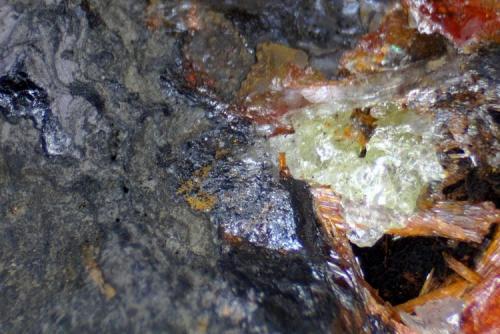 Petterdite (and cerussite, crocoite and galena)
Red Lead Mine, Dundas, Tasmania, Australia
Photo width is 11mm (Author: crocoite)