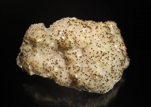 Dolomite
Cavnic, Maramures, Romania
6.1 x 8.7 cm.
White to pale tan dolomite rhombs arranged in several mounds on a quartz matrix.  Small irridescent brown sphaerosiderites accent the specimen. (Author: crosstimber)