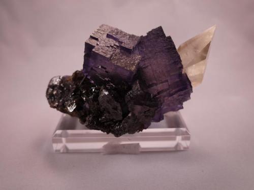 Fluorite, Calcite, Sphalerite
Elmwood Mine, Smith County,  Tennessee, USA
12.5 x 7.5 x 6.5 cm
The Fluorite has razor sharp edges

The Calcite has a perfect sharp termination (Author: Don Lum)